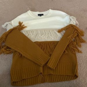 Crew style sweater. Only worn 2-3 times. Fringe at the middle of the sweater.